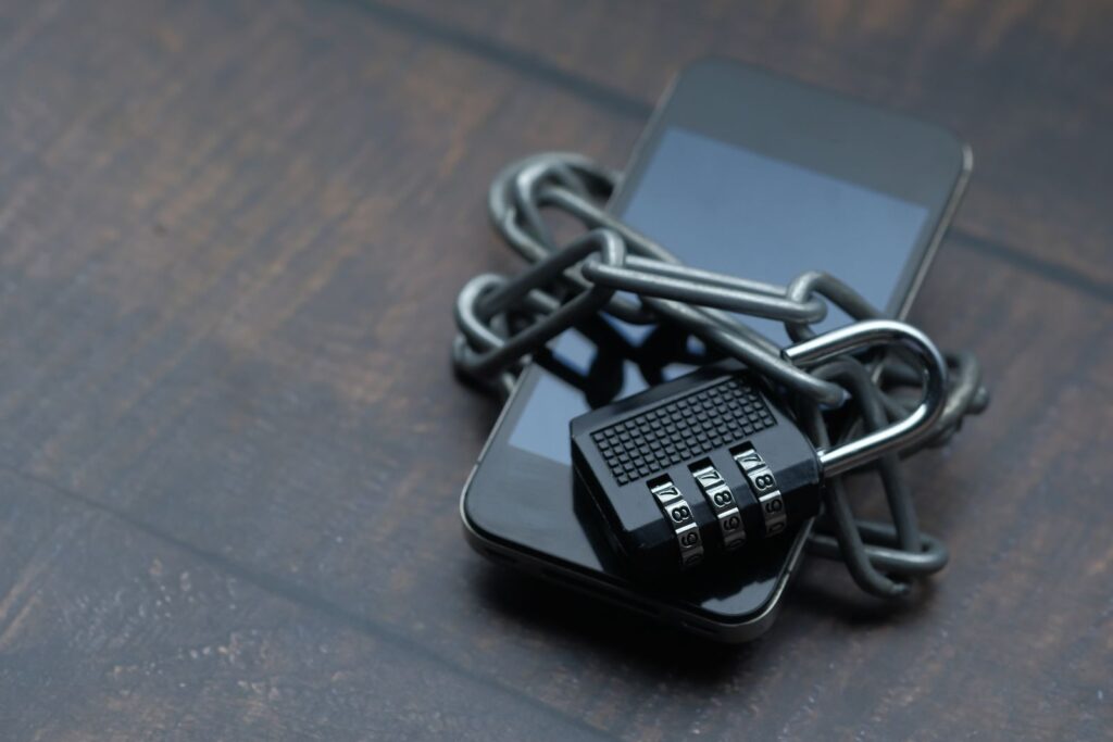 Smartphone wrapped in a chain with a padlock, symbolizing password manager encryption