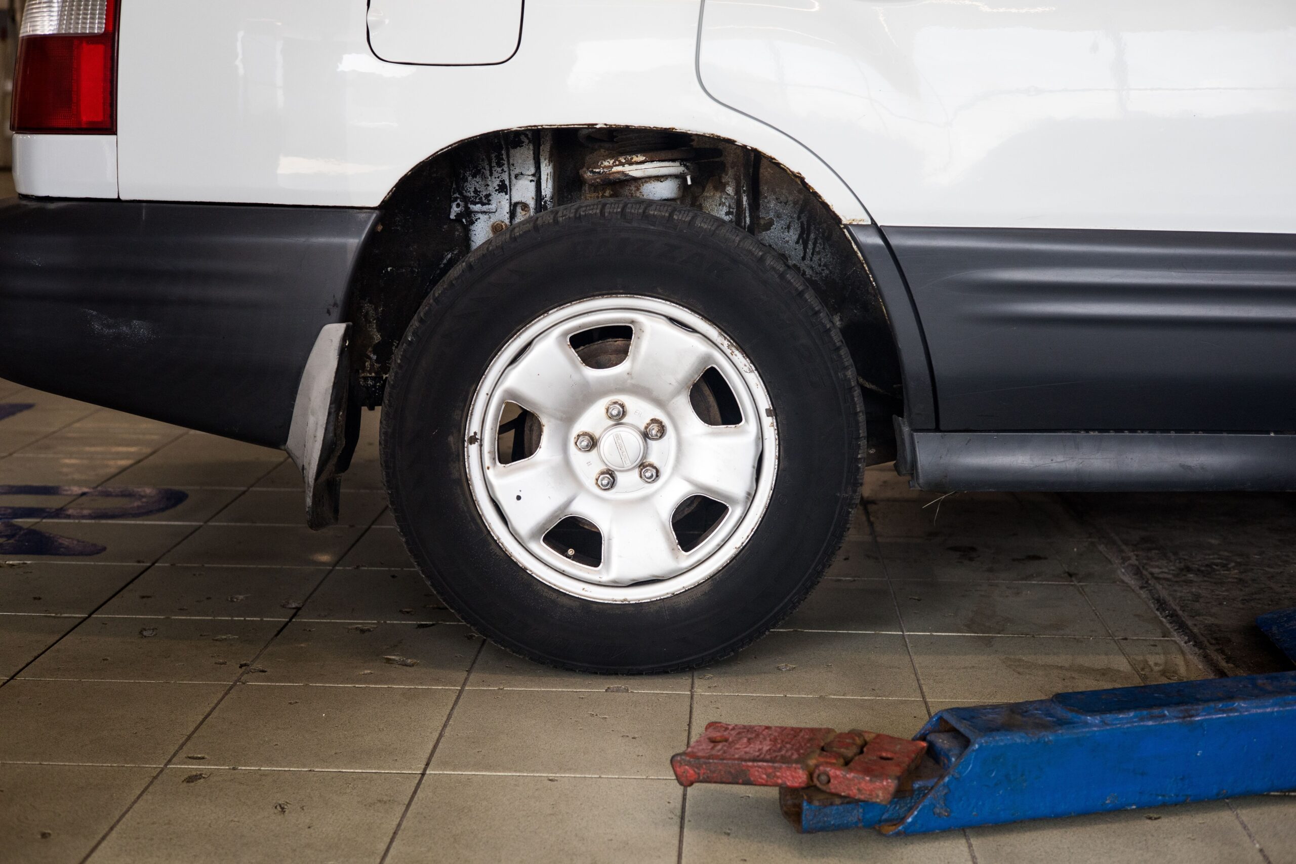 Car wheel lifted on a jack with the tire removed during a tire change