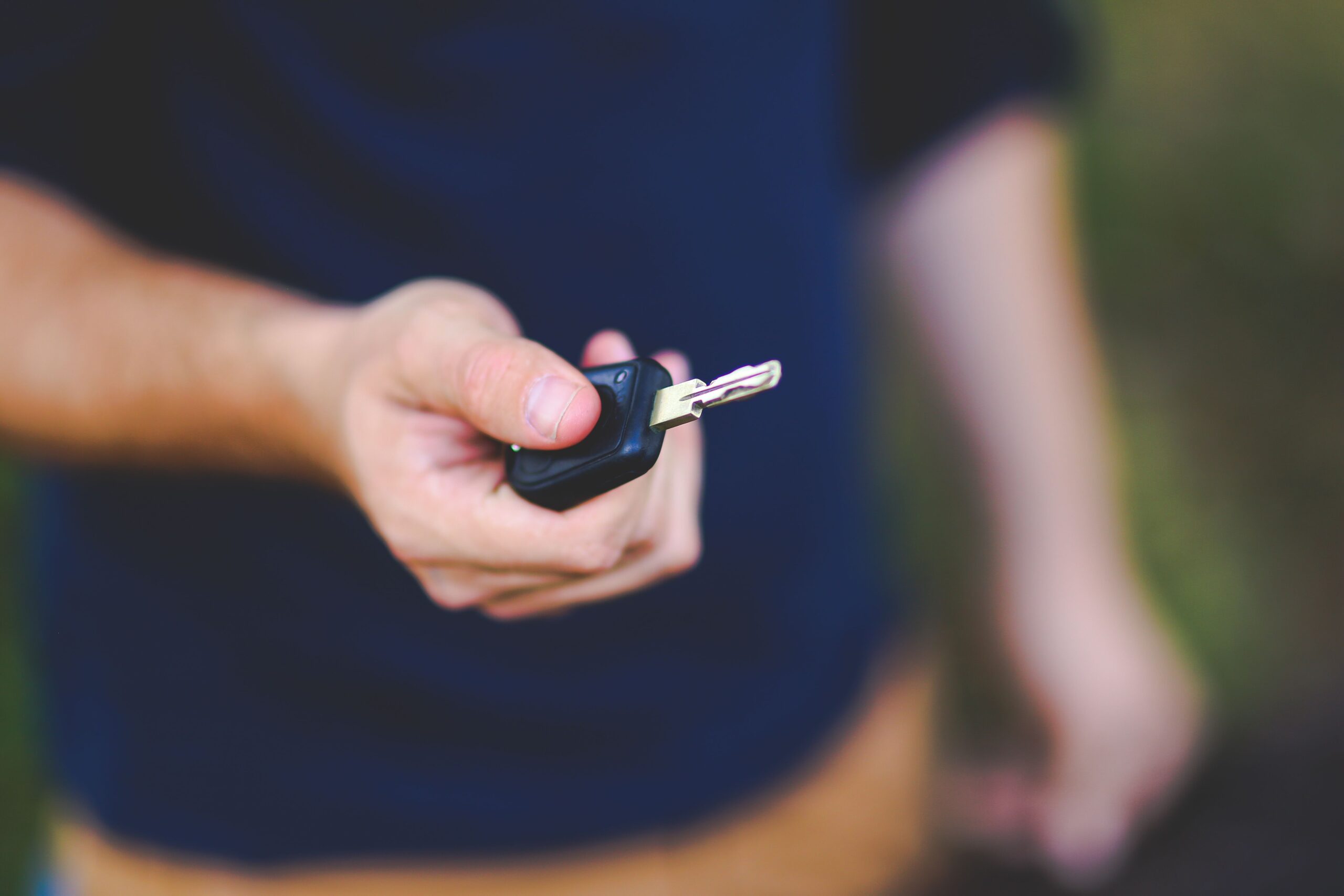 Hand holding a car key fob