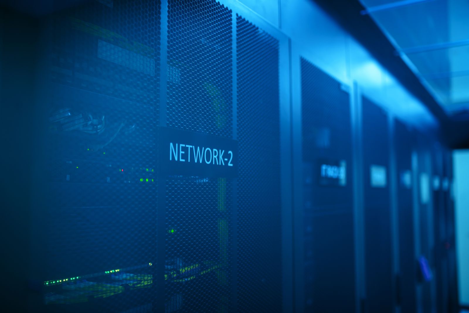 Close-up of a network equipment rack with cabling, representing firewall deployment hardware