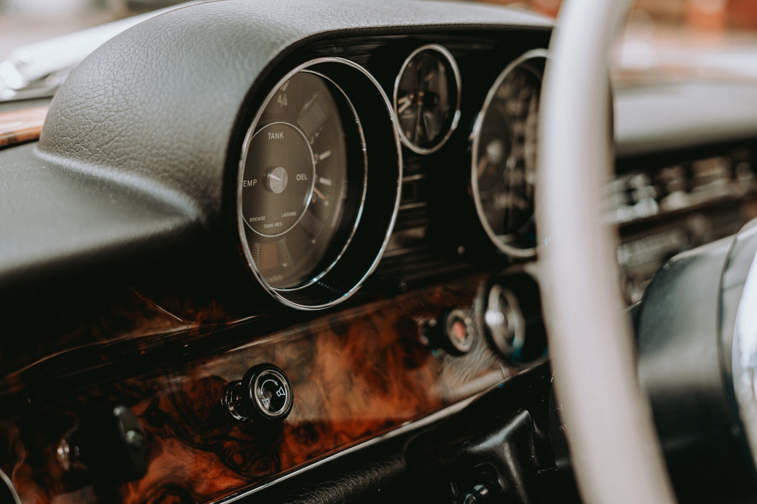 Close-up of a classic car's analog dashboard gauges