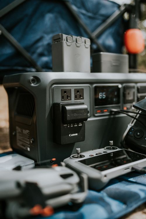 Portable power station running camera and drone gear at an outdoor campsite, one of the best portable power stations 2026 use cases