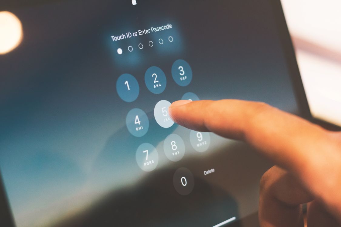 Entering a passcode on a phone, illustrating the 1Password vs Bitwarden password manager choice