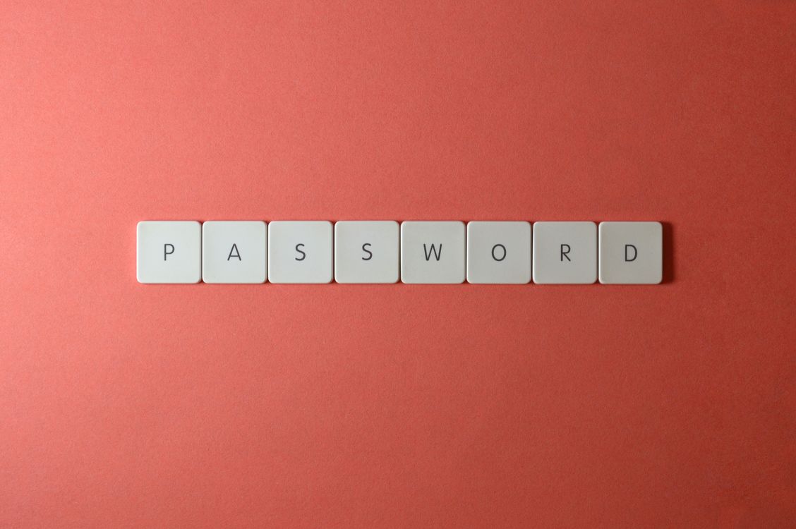 Keyboard tiles spelling PASSWORD, representing the 1Password vs Bitwarden comparison