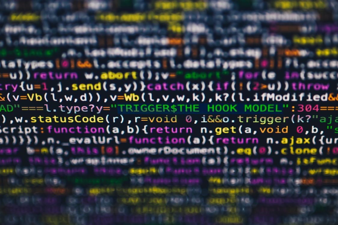 Lines of colorful code on a screen, representing the statistical patterns behind AI text watermarking